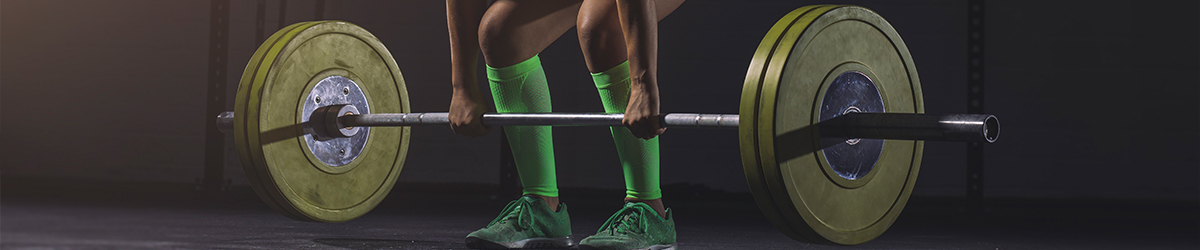 Young woman lifting barbell