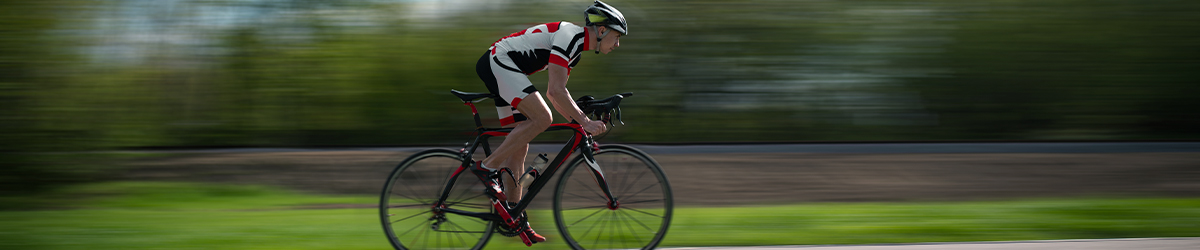 Cyclist rides on bicycle, speed effect, side view